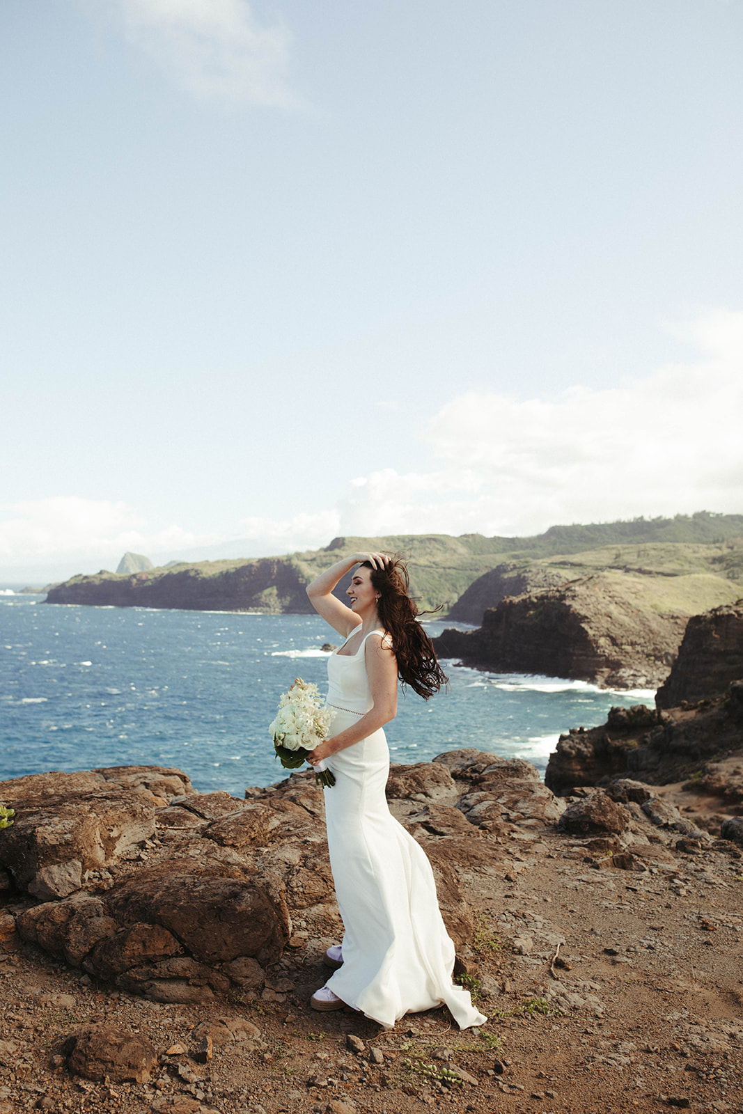 bridal portrait on hawaiian cliffside after the intimate destination elopement ceremony